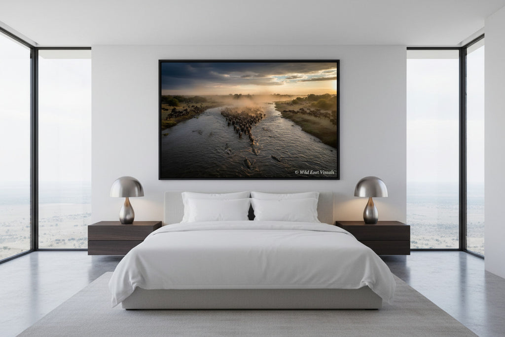 The Crossing — Dust & Thunder fine art giclée print displayed above a king bed in a modern luxury bedroom — Great Wildebeest Migration wildlife wall art — Wild East Visuals