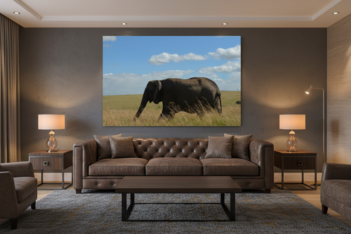 Across the Mara — Lone Elephant fine art print displayed in a dark luxury living room, charcoal wall, leather sofa, warm accent lighting, no frame — Wild East Visuals