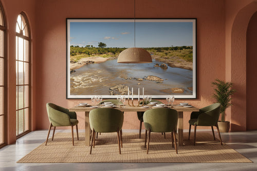 Before the Crossing — Mara River fine art print displayed in a luxury dining room with terracotta walls and warm afternoon light — Wild East Visuals