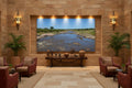 Before the Crossing — Mara River fine art print displayed in a grand luxury hotel lobby with warm stone walls and African-inspired decor — Wild East Visuals