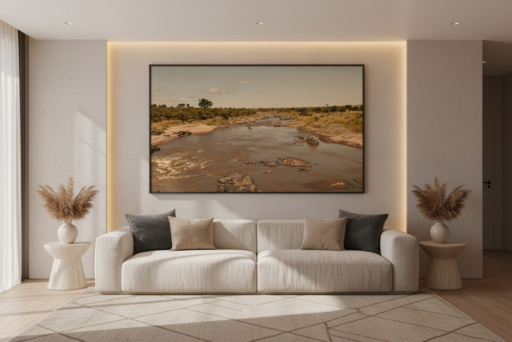 Before the Crossing — Mara River fine art print displayed above a modern luxury living room sofa, wide format — Wild East Visuals