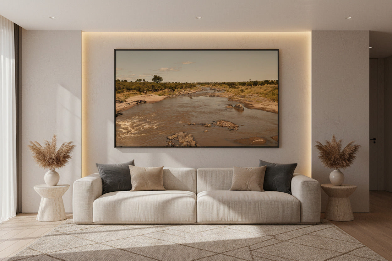 Before the Crossing — Mara River fine art print displayed above a modern luxury living room sofa, wide format — Wild East Visuals