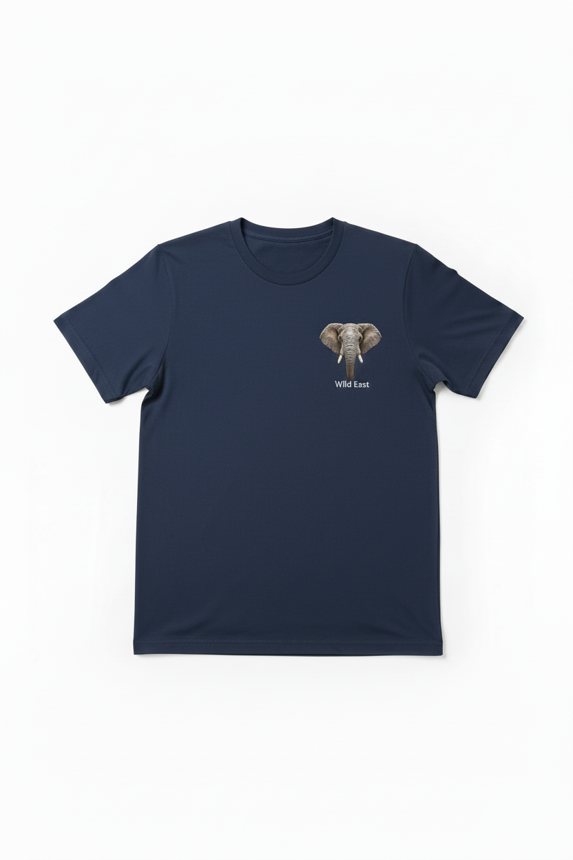 Wild East Navy Tee flat lay — precision elephant badge on the left chest, 100% cotton 180gsm, limited to 100 pieces per size. Handcrafted in Nairobi, Kenya. Wild East Visuals.