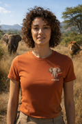 Woman wearing Wild East Terracotta Tee on safari with elephants in background, Wild East Visuals