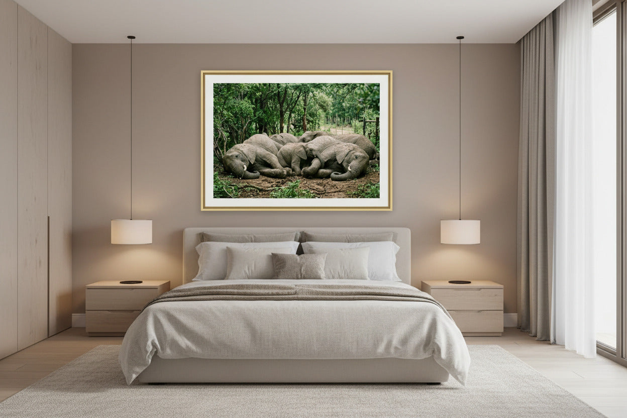 The Uninvited Guests elephant herd print framed on a bedroom wall — Wild East Visuals
