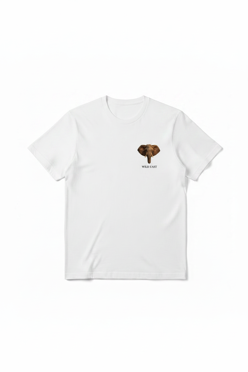 Wild East White Tee flat lay — precision elephant badge on the left chest, 100% cotton 180gsm, limited to 100 pieces per size. Handcrafted in Nairobi, Kenya. Wild East Visuals.